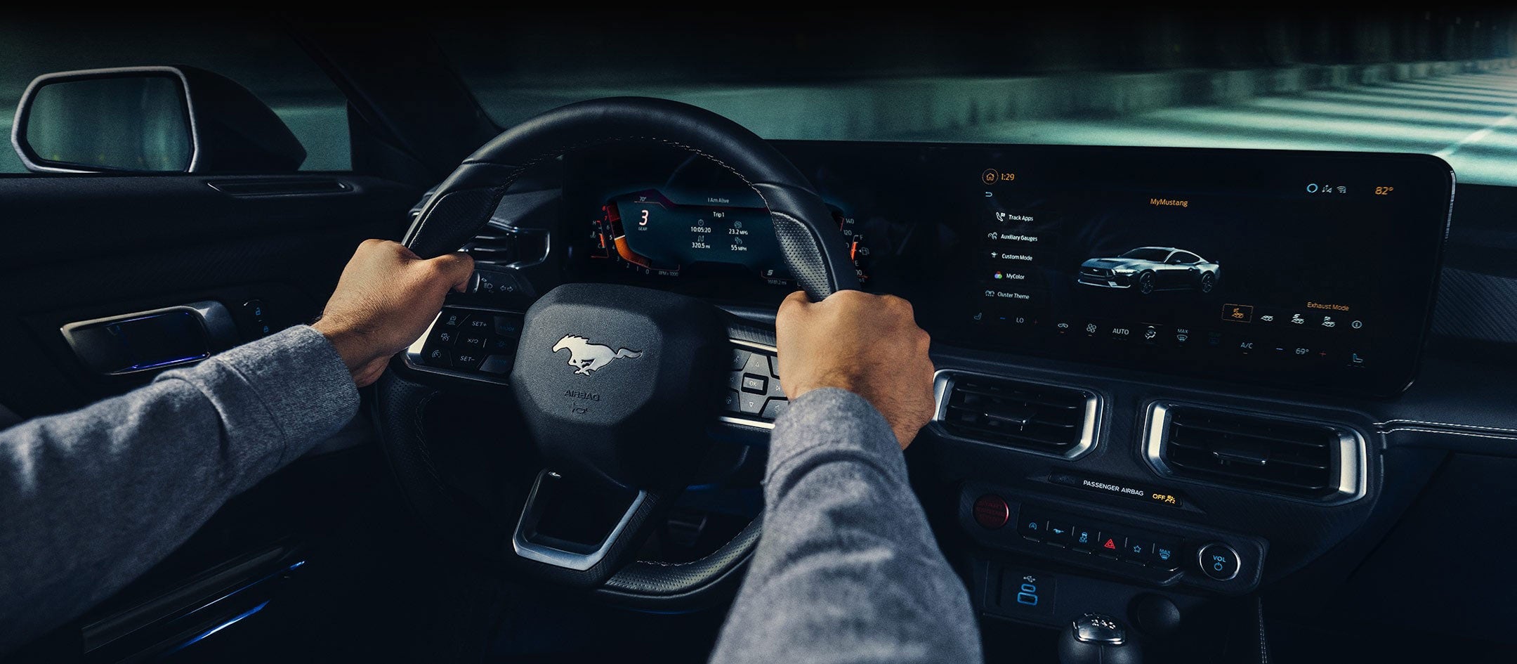 A 2024 Ford Mustang® model interior with a person driving | Jim Hudson Ford in Lexington SC